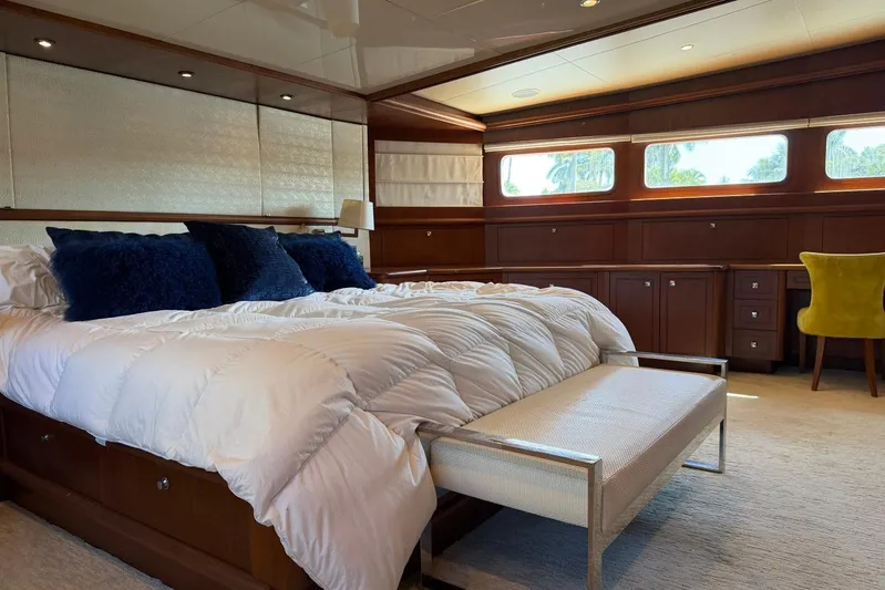  Yacht Photos Pics Luxurious bedroom interior on 1990 Heesen 144 yacht with elegant furnishings and natural light.