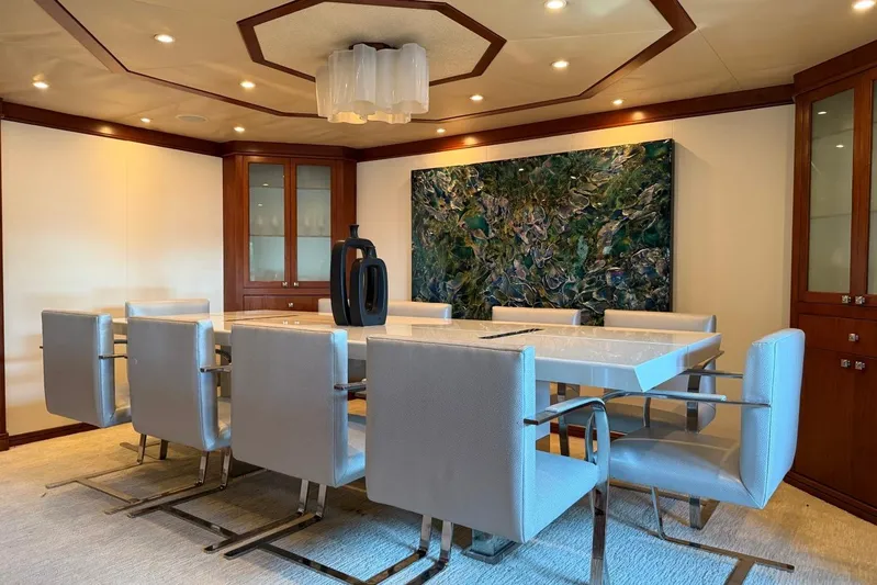  Yacht Photos Pics Luxurious dining area on 1990 Heesen 144 yacht with modern decor and elegant furnishings.