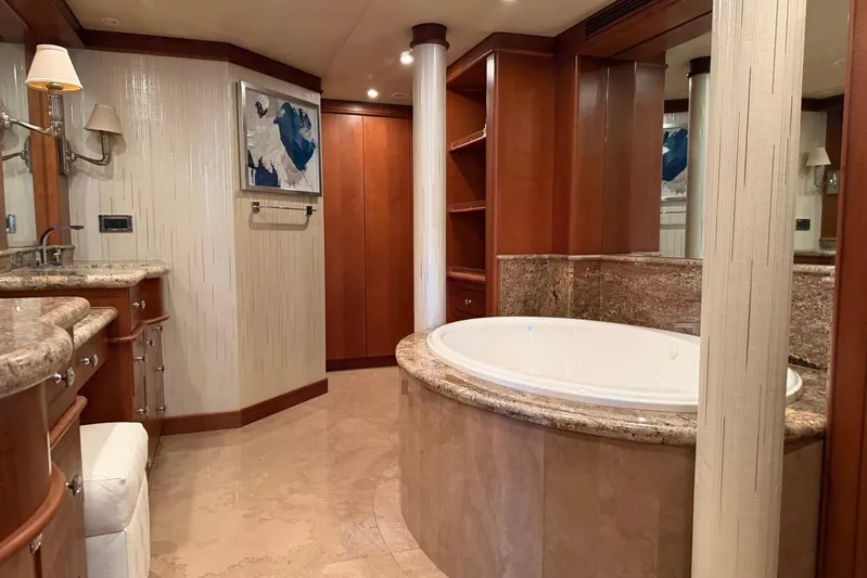  Yacht Photos Pics Luxurious yacht bathroom with marble tub, wooden cabinetry, and elegant lighting, Heesen 144, 1990 model.