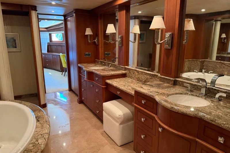  Yacht Photos Pics Luxurious bathroom interior on 1990 Heesen 144 yacht with marble countertops and elegant wood cabinetry.