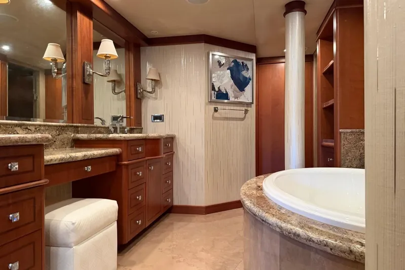  Yacht Photos Pics Luxurious bathroom interior on 1990 Heesen 144 yacht, featuring elegant wood cabinetry and marble accents.