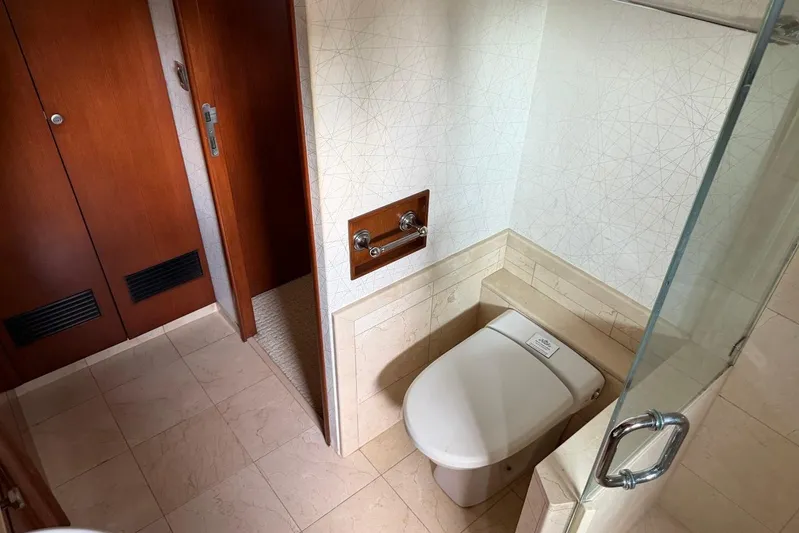  Yacht Photos Pics Luxurious bathroom on 1990 Heesen 144 yacht, featuring modern fixtures and elegant wood accents.