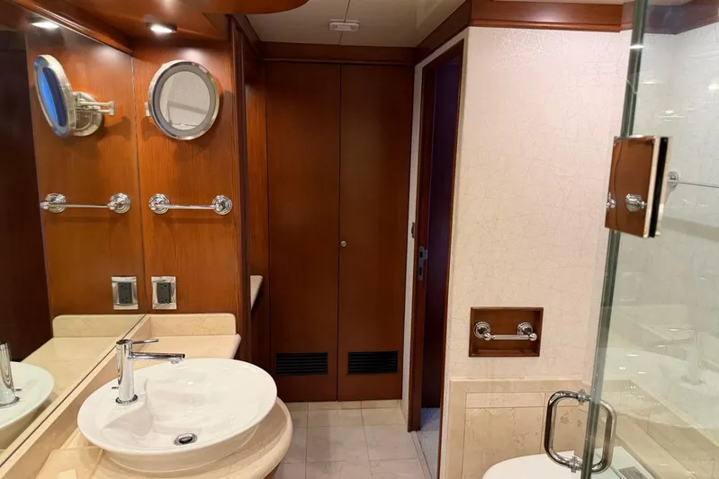  Yacht Photos Pics Luxurious bathroom interior of 1990 Heesen 144 yacht with wooden accents and modern fixtures.