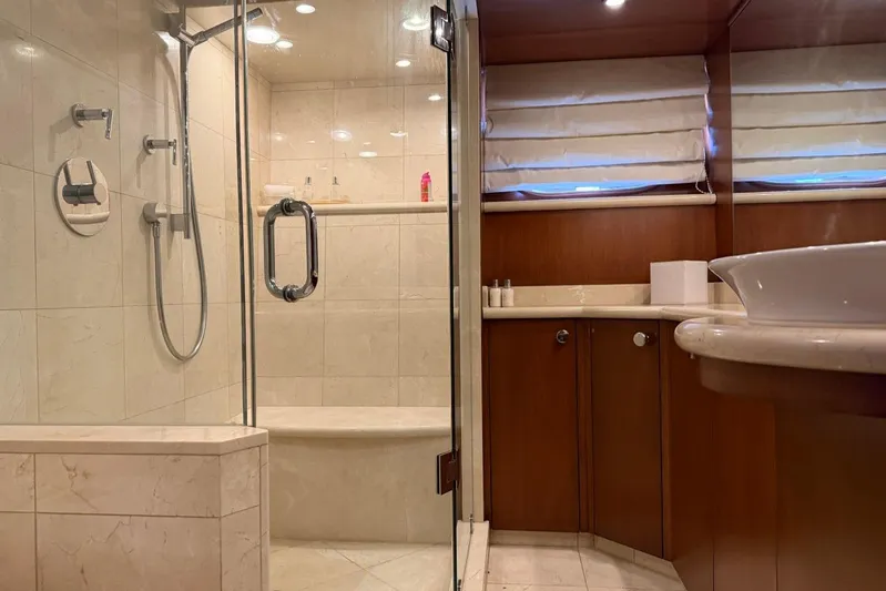  Yacht Photos Pics Luxurious bathroom in 1990 Heesen 144 yacht with glass shower and elegant fixtures.