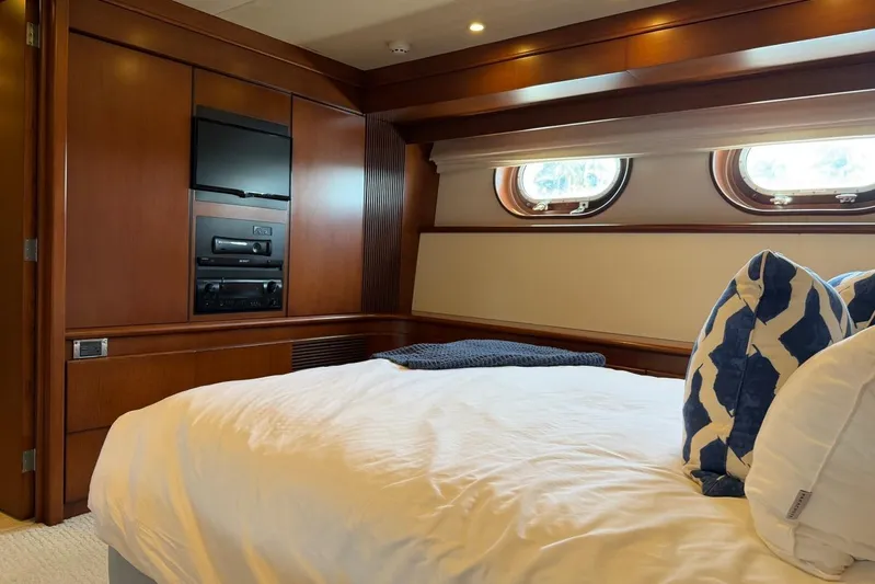 Yacht Photos Pics Luxurious Heesen 144 yacht bedroom interior with wood paneling and porthole windows, 1990 model.