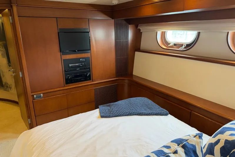  Yacht Photos Pics Luxurious Heesen 144 yacht bedroom interior with wood paneling and porthole window, 1990 model.