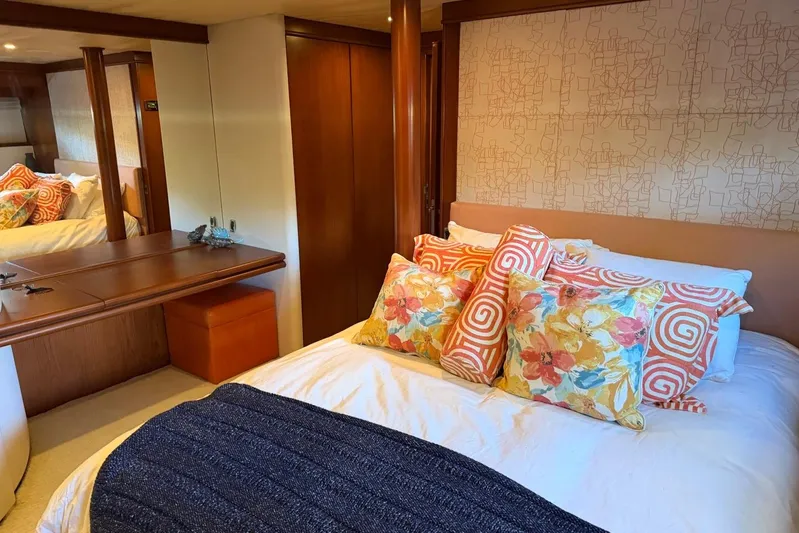  Yacht Photos Pics Luxurious bedroom interior on 1990 Heesen 144 yacht with vibrant pillows and elegant decor.