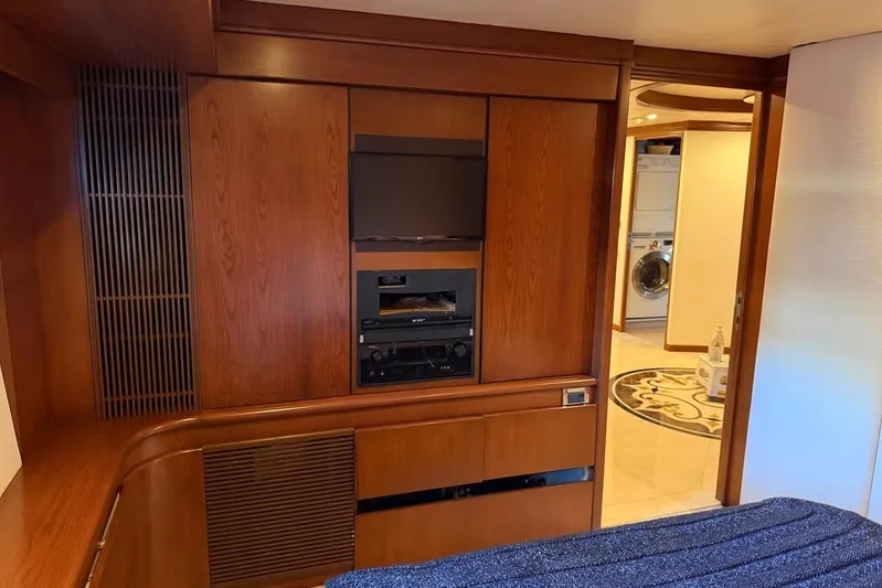  Yacht Photos Pics Luxurious Heesen 144 yacht interior with wood paneling, TV, and laundry area, built in 1990.