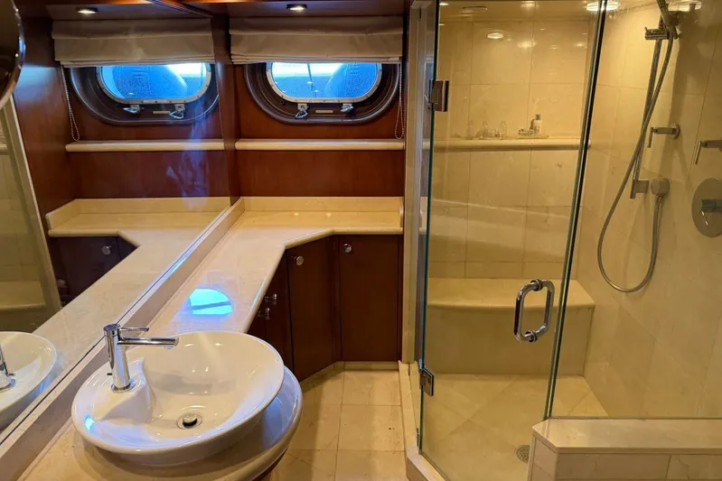  Yacht Photos Pics Luxurious bathroom on 1990 Heesen 144 yacht with glass shower and elegant fixtures.