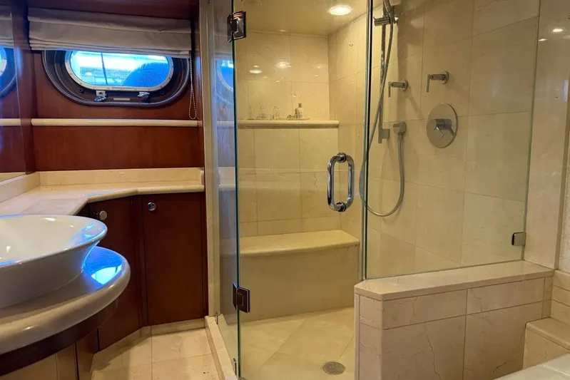  Yacht Photos Pics Luxurious bathroom in 1990 Heesen 144 yacht with glass shower and elegant fixtures.