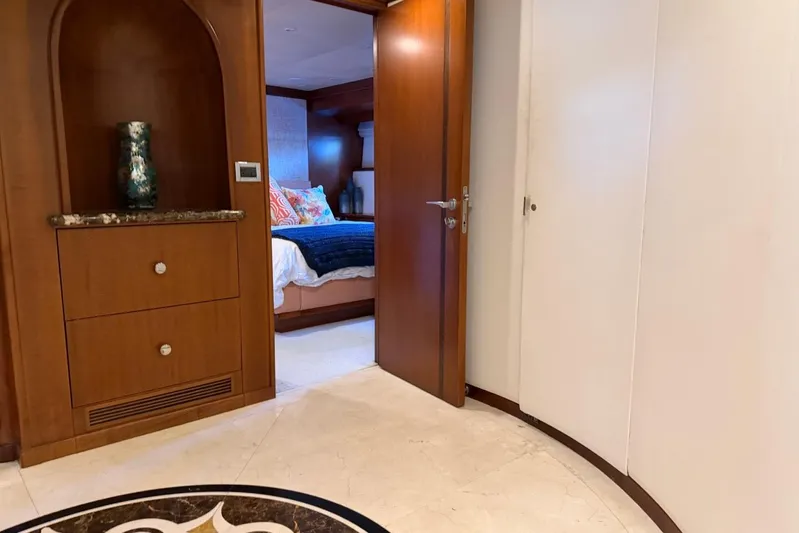  Yacht Photos Pics Luxurious Heesen 144 yacht interior, featuring elegant woodwork and a cozy bedroom, built in 1990.