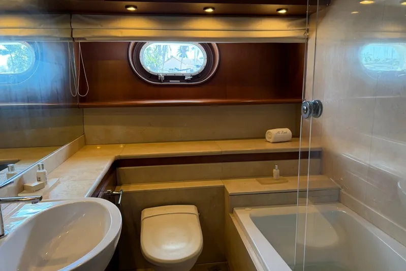  Yacht Photos Pics Luxurious bathroom interior on a 1990 Heesen 144 yacht, featuring elegant fixtures and porthole window.