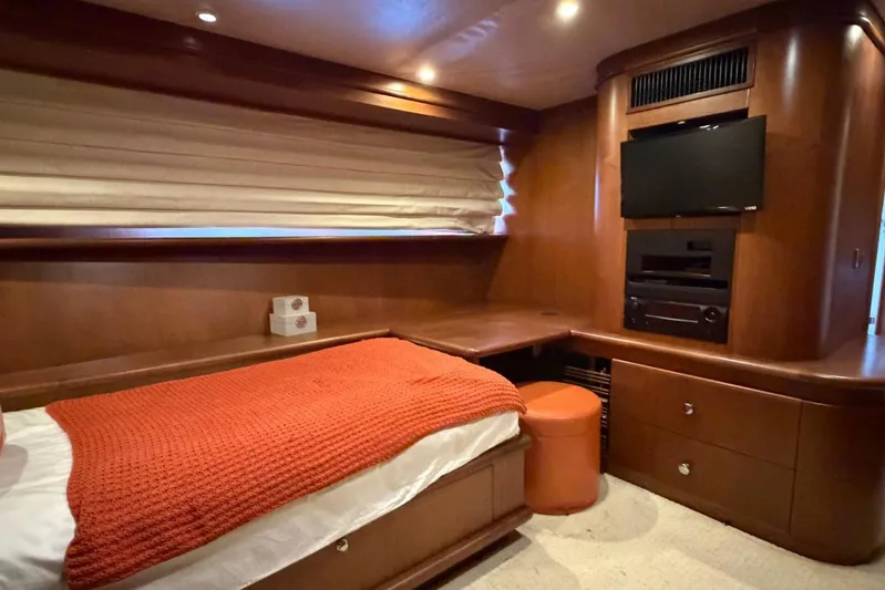  Yacht Photos Pics Luxurious Heesen 144 yacht bedroom, 1990 model, featuring wood paneling and modern entertainment system.