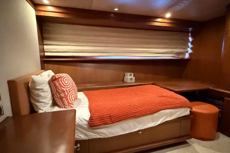  Yacht Photos Pics Luxurious cabin interior of 1990 Heesen 144 yacht with cozy bed and warm decor.