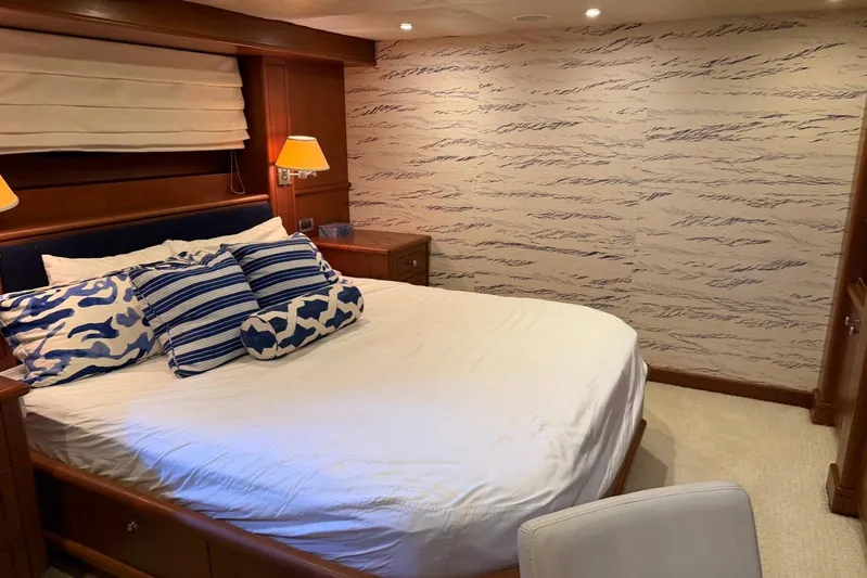  Yacht Photos Pics Luxurious bedroom interior on 1990 Heesen 144 yacht with elegant decor and cozy bedding.