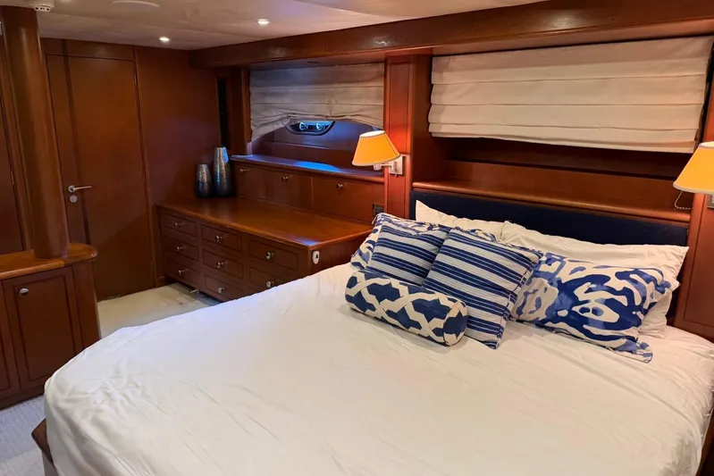  Yacht Photos Pics Luxurious bedroom interior on 1990 Heesen 144 yacht with elegant wood finish and stylish decor.
