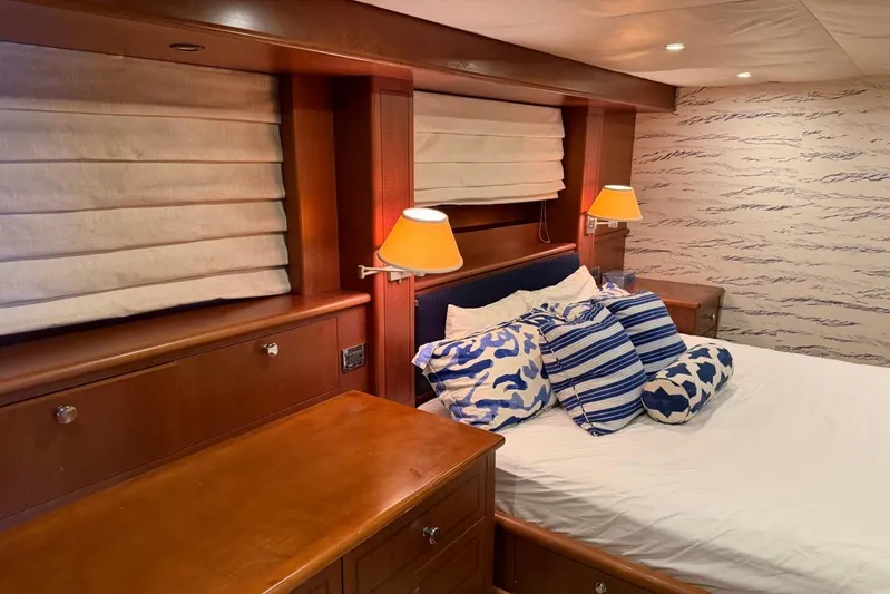  Yacht Photos Pics Luxurious bedroom interior on 1990 Heesen 144 yacht with elegant wood finish and stylish decor.