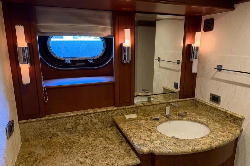  Yacht Photos Pics Luxurious yacht bathroom with granite countertop, mirror, and porthole window on a 1990 Heesen 144.