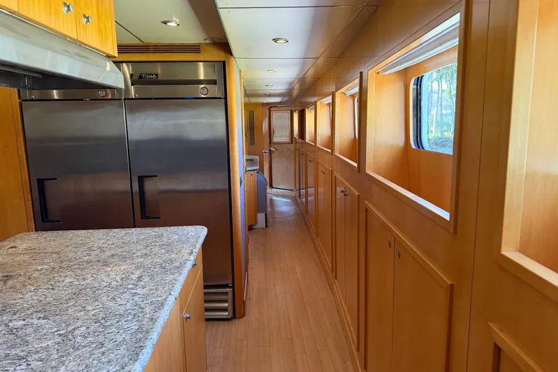  Yacht Photos Pics Luxurious Heesen 144 yacht interior with modern kitchen, stainless steel appliances, and wood paneling, 1990 model.