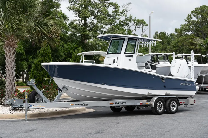  Yacht Photos Pics 2026 Blackfin 262 HB boat on trailer, parked outdoors with trees in background.