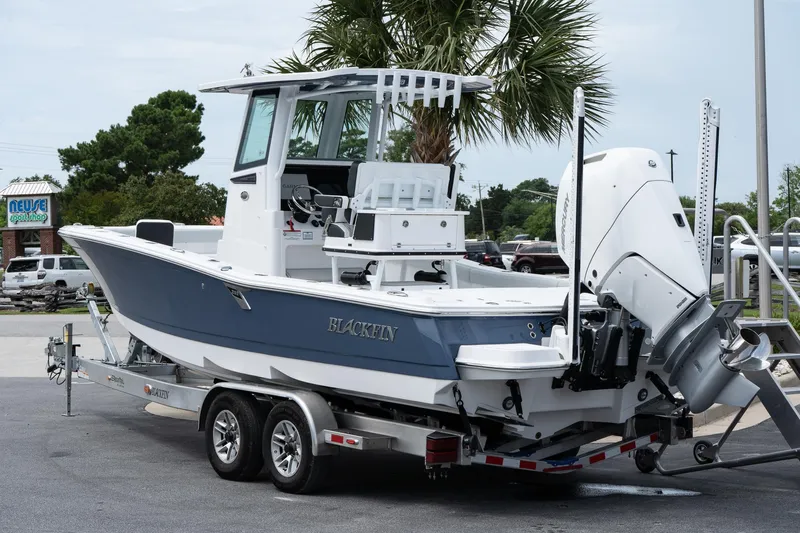  Yacht Photos Pics 2026 Blackfin 262 HB boat on trailer, parked outdoors near palm tree.