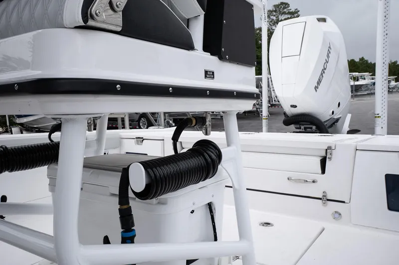  Yacht Photos Pics 2026 Blackfin 262 HB boat interior with Mercury engine, showcasing seating and storage features.
