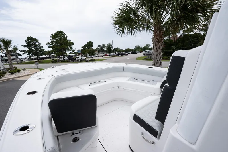  Yacht Photos Pics 2026 Blackfin 262 HB boat interior with seating, parked near palm trees.