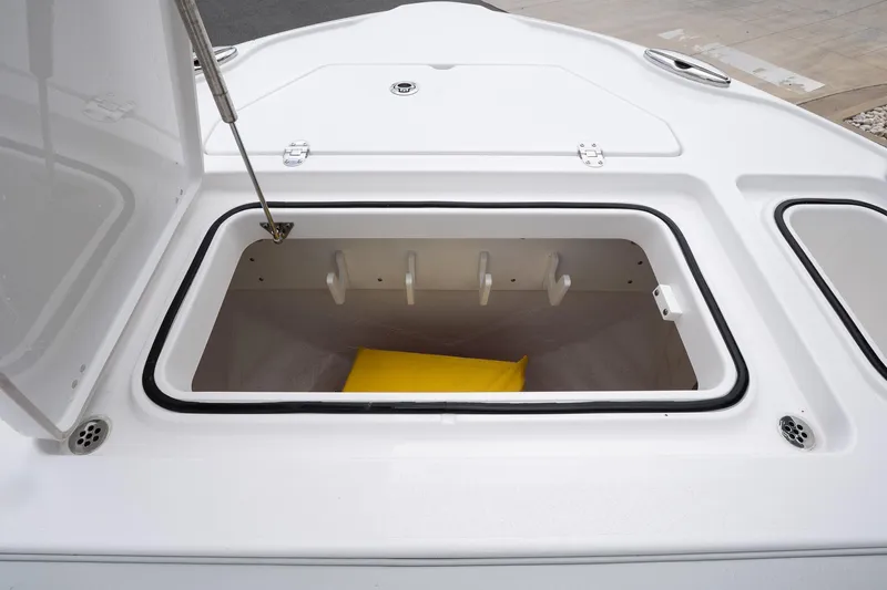  Yacht Photos Pics Open storage compartment on 2026 Blackfin 262 HB boat, featuring a yellow cushion inside.
