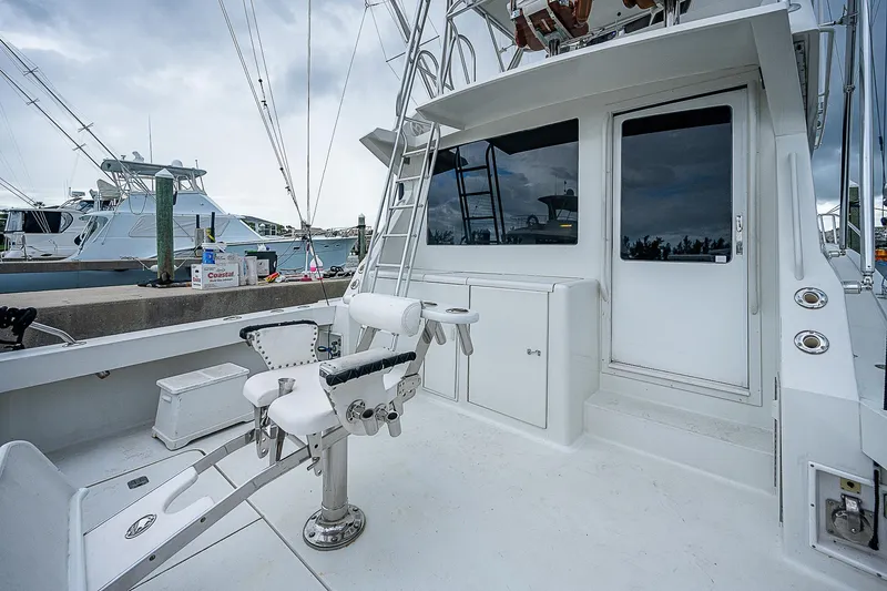  Yacht Photos Pics 1998 Viking 47 Convertible yacht with fishing chair and ladder, docked at marina.