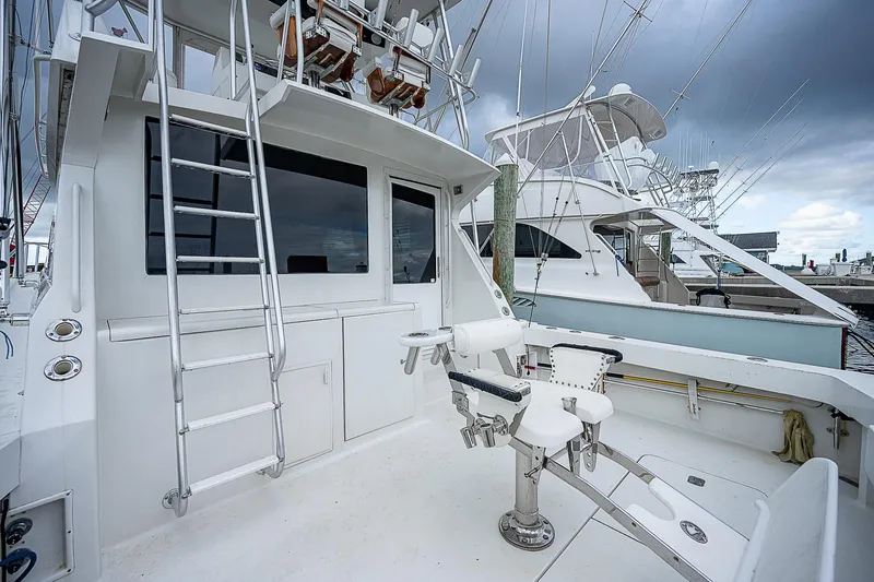  Yacht Photos Pics 1998 Viking 47 Convertible yacht with fishing equipment and ladder, docked at marina.