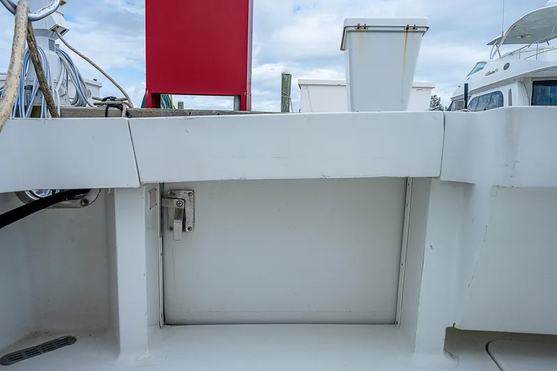  Yacht Photos Pics 1998 Viking 47 Convertible boat deck with storage compartment and marine equipment.