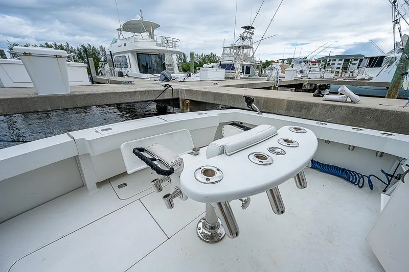  Yacht Photos Pics 1998 Viking 47 Convertible yacht at marina, featuring fishing rod holders and spacious deck.