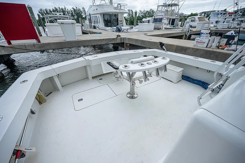  Yacht Photos Pics 1998 Viking 47 Convertible yacht deck at marina, featuring fishing rod holders and spacious layout.