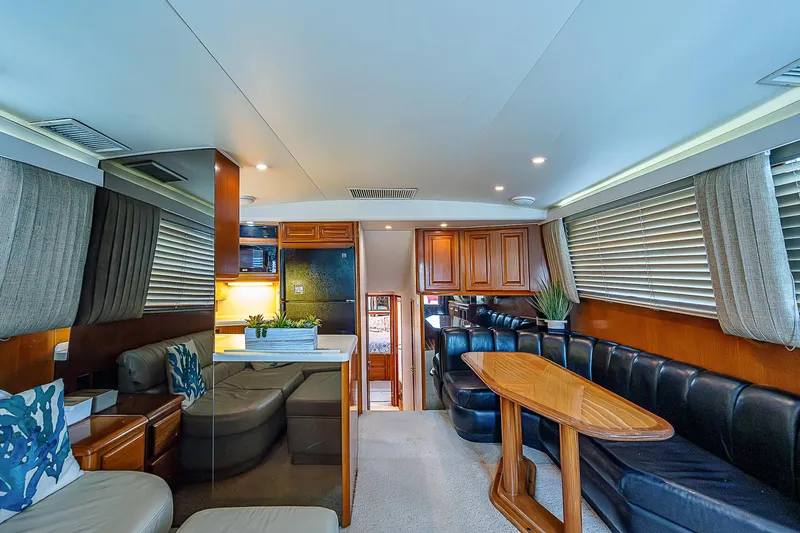  Yacht Photos Pics Luxurious interior of a 1998 Viking 47 Convertible yacht with elegant seating and wooden accents.