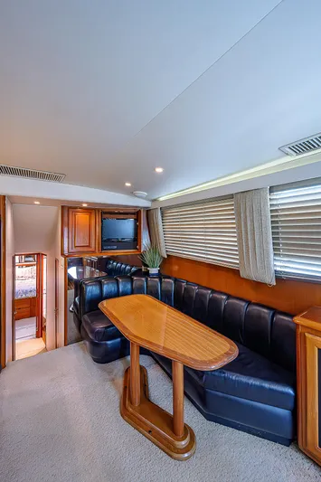  Yacht Photos Pics Interior of 1998 Viking 47 Convertible yacht with leather seating and wooden table.
