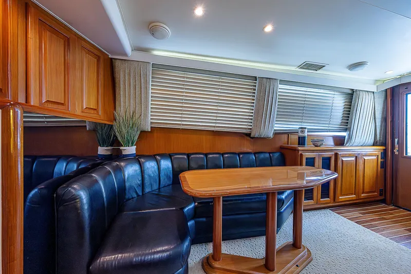  Yacht Photos Pics Luxurious interior of 1998 Viking 47 Convertible yacht with leather seating and wooden table.
