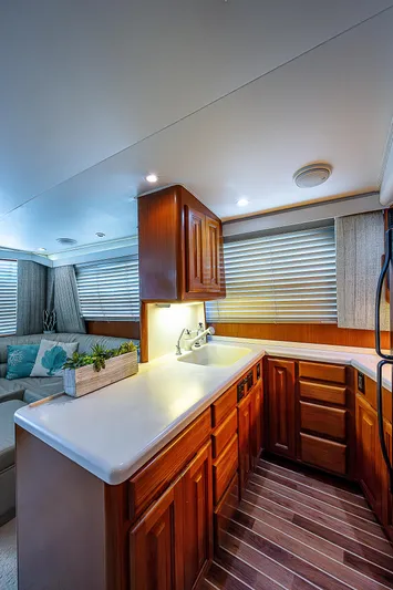  Yacht Photos Pics 1998 Viking 47 Convertible yacht interior with wooden cabinetry and modern lighting.