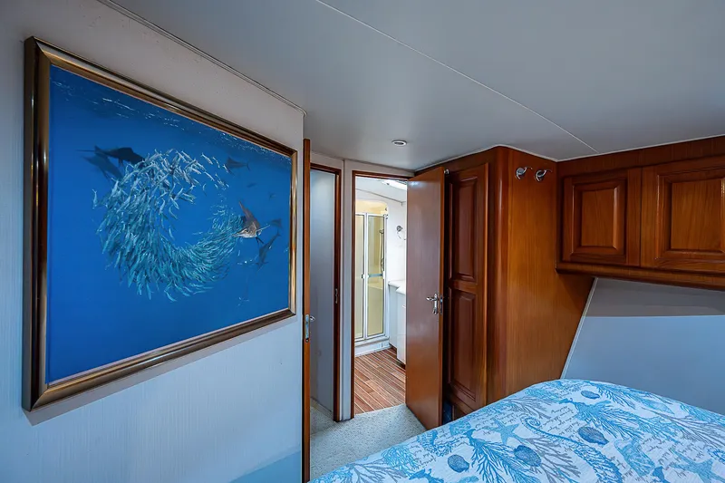  Yacht Photos Pics Interior of 1998 Viking 47 Convertible yacht with ocean-themed artwork and wooden cabinetry.