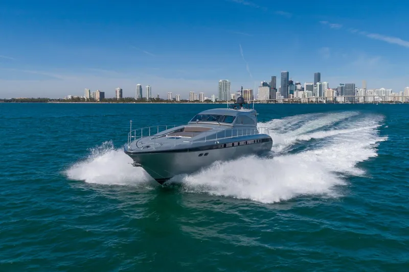 Happy One Yacht Photos Pics 2007 Leopard Express Motor Yacht cruising near city skyline on blue ocean waters.