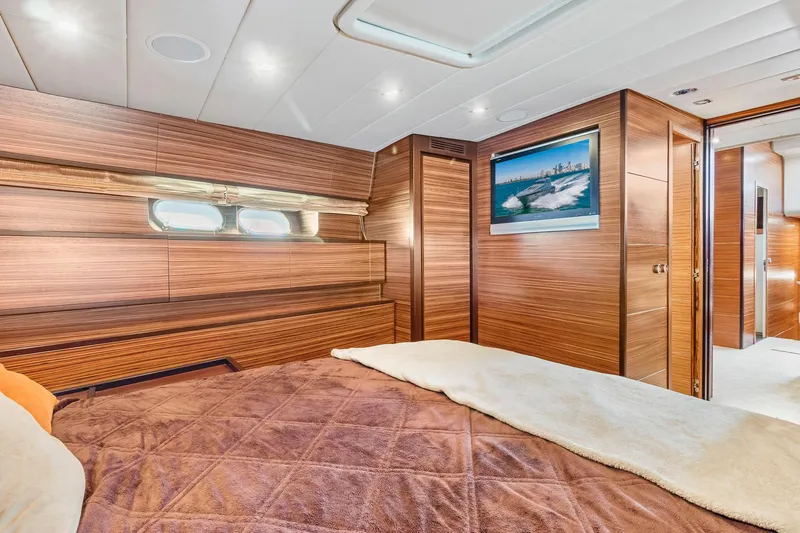 Happy One Yacht Photos Pics Luxurious 2007 Leopard Express Motor Yacht bedroom with wood paneling and modern decor.