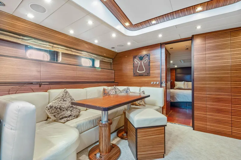 Happy One Yacht Photos Pics Luxurious 2007 Leopard Express Motor Yacht interior with elegant wood paneling and plush seating.