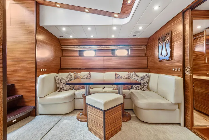Happy One Yacht Photos Pics Luxurious 2007 Leopard Express Motor Yacht interior with elegant wood paneling and plush seating.