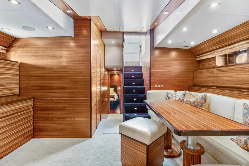 Happy One Yacht Photos Pics Luxurious interior of 2007 Leopard Express Motor Yacht with wood paneling and elegant seating.