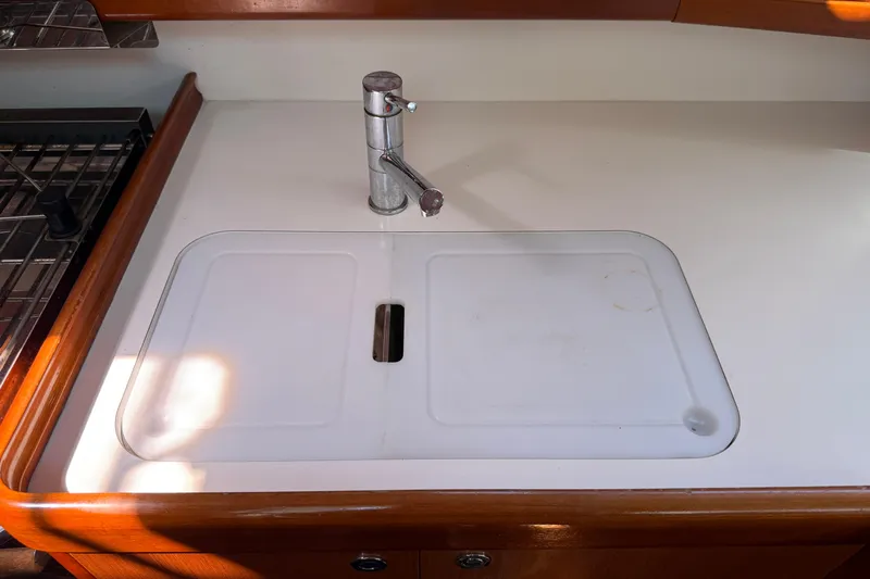 Magic Maddie 2 Yacht Photos Pics Galley sink area on 2010 Beneteau Oceanis 43 sailboat, featuring a sleek faucet.