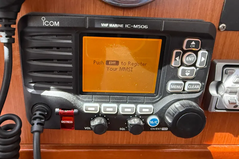 Magic Maddie 2 Yacht Photos Pics VHF marine radio on 2010 Beneteau Oceanis 43 sailboat, displaying MMSI registration prompt.