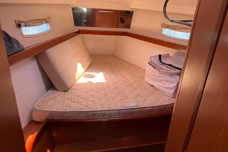 Magic Maddie 2 Yacht Photos Pics Cozy cabin interior of 2010 Beneteau Oceanis 43 sailboat with mattress and life jackets.
