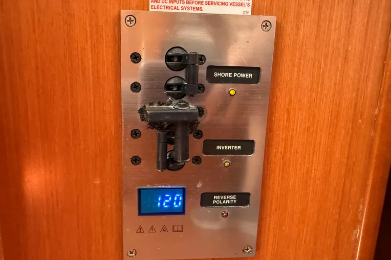 Magic Maddie 2 Yacht Photos Pics Electrical panel on a 2010 Beneteau Oceanis 43 yacht, showing shore power and inverter controls.