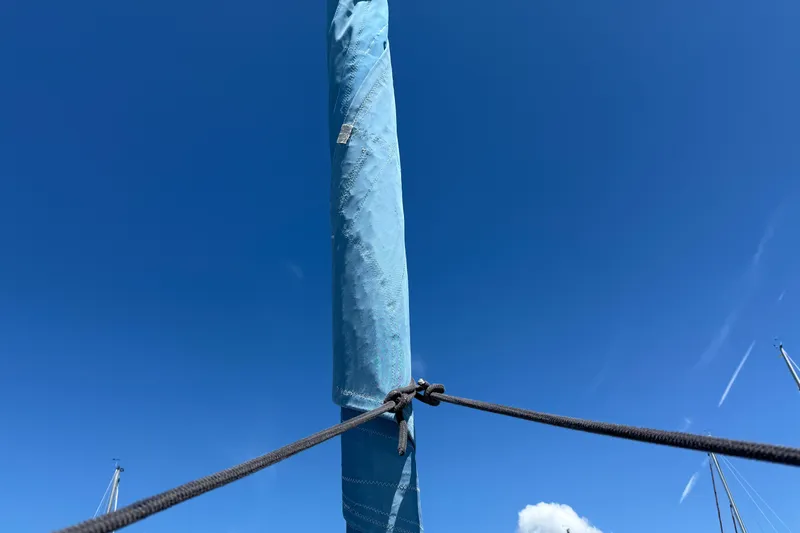 Magic Maddie 2 Yacht Photos Pics Mast of 2010 Beneteau Oceanis 43 sailboat against clear blue sky.