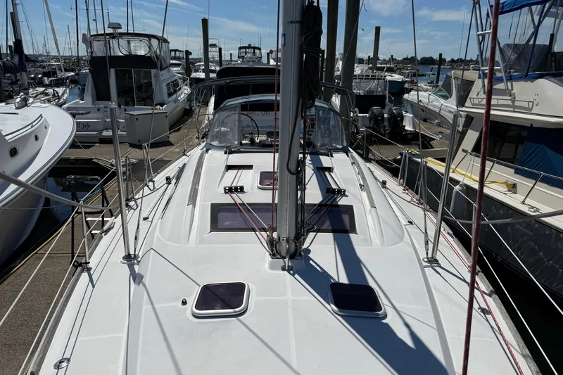 Magic Maddie 2 Yacht Photos Pics 2010 Beneteau Oceanis 43 sailboat docked at a marina under clear blue skies.