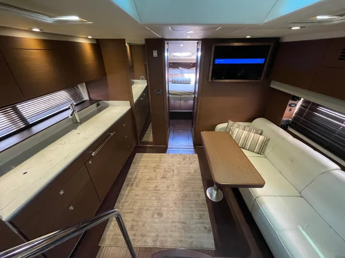 Southern Accent Yacht Photos Pics Luxurious interior of 2014 Sea Ray 470 Sundancer yacht with modern kitchen and seating area.